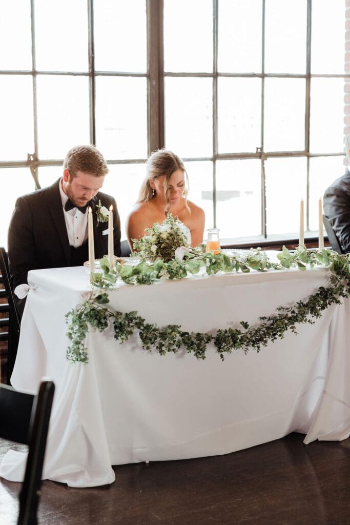 Couple at sweetheart table at Nashville wedding venue Room With A View