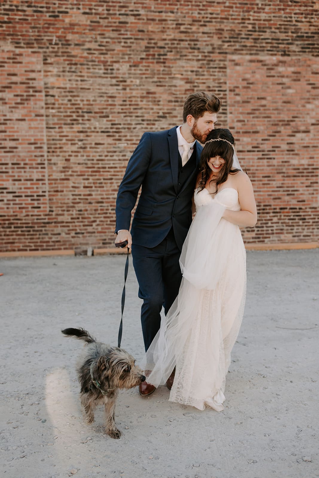 Couple walking with dog outside at Nashville wedding venue Room With A View.