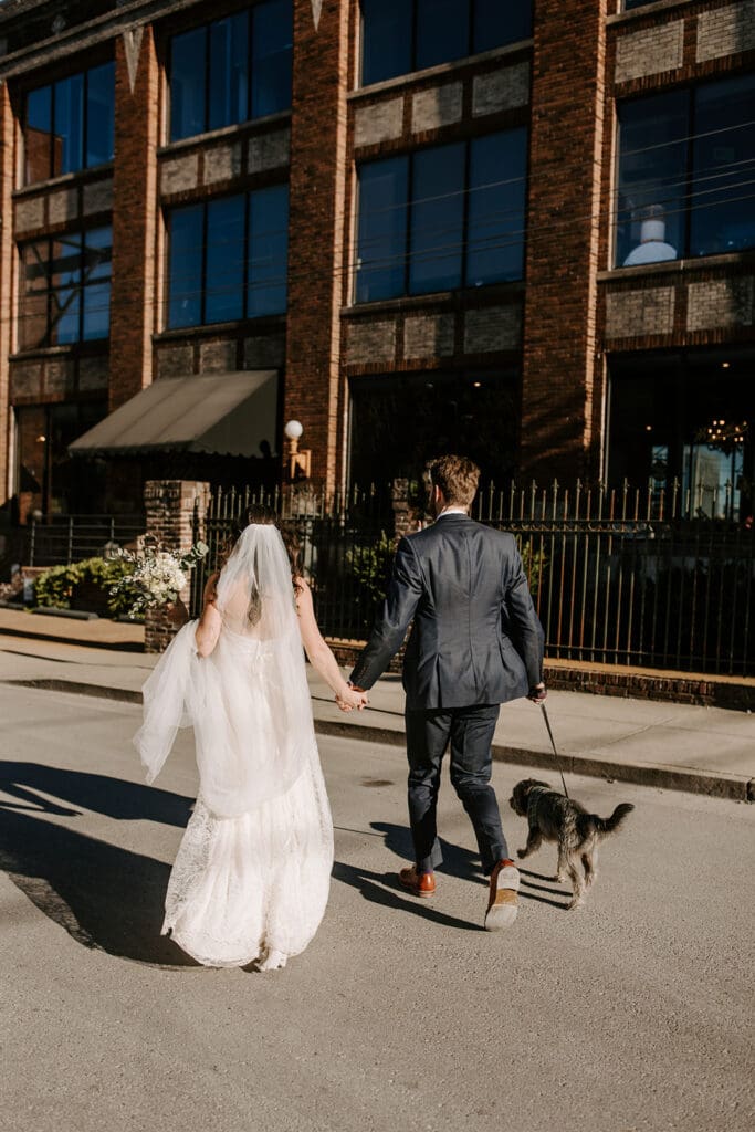 Couple walking dog outside at Nashville wedding venue Room With A View.